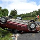 Dylan Cliff (right) stands with Constable Dean Clarkson, of Dunedin, after his car flipped on Mt...