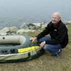 Dunedin Marine Search and Rescue chairman Martin Balch examines the craft that carried three...