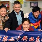 Dunedin Mayor Dave Cull gives pupils from the Qi Bao No.2 Middle School in Shanghai a sample of...