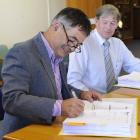 Dunedin Mayor Dave Cull signs the $26.7 million contract for Dunedin's new kerbside collection...