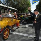 Dunedin Mayor Dave Cull waves off Chris and Pam Read in a 1914 Delage in the Octagon on Saturday....