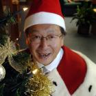 Dunedin Mayor Peter Chin gets into the Christmas spirit in his chambers yesterday, in preparation...