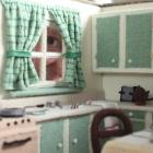 Dunedin Miniaturist Club member Jill York looks through the window of the miniature kitchen she...