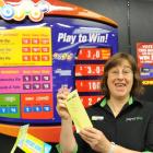 Dunedin Paper Plus owner Jacqui Brenssell holds Saturday night's Lotto result. Photo by Peter...