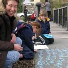 Dunedin poet Sue Wootton (left) at a pavement poetry day with Wanaka Primary School pupils...