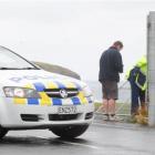 Dunedin police and Delta Utility Services staff on John Wilson Ocean Dr yesterday, where the...