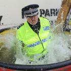 Dunedin police Inspector Alastair Dickie throws himself into "Dunk a Cop" fun in Dunedin on...
