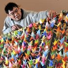 Dunedin Public Art Gallery technician Russell Soo examines the 1000 origami cranes. Photo by...