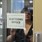 Dunedin returning officer Pam Jordan takes down the elections office sign  at the DCC at noon...