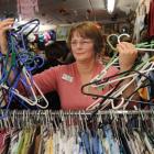 Dunedin's Butterflies Hospice Shop supervisor Robyn Elliman holds empty hangers representing the...