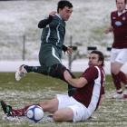 Dunedin Technical midfielder  Blair Scoullar (on ground) makes a tackle on Bay Olympic midfielder...