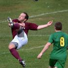 Dunedin Technical player Alastair Rickerby clears the ball as Green Island’s Andy Marshall looks...