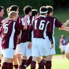 Dunedin Technical players rush to congratulate Blair Scoullar (right) after his goal in Saturday...