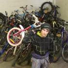 Dunedin Training Centre trainee Zane Grant (17) moves the consignment of Christchurch bikes...