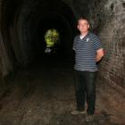 Dunedin Tunnels Trail Trust trustee Gerard Hyland inspects  the Chain Hills tunnel at Wingatui....