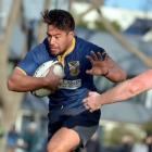 Dunedin utility back Trent Renata is stopped in his tracks by Alhambra-Union halfback Caleb Gray...