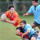 Dunstan High School second five-eighth Rowan Tumai is tackled by Kings High School halfback Caleb...