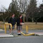 Dunstan High School year 10 pupils Erin Calder (14, left) and Meg McCone (15) cross the busy...
