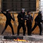 Egyptian police throw stones at protesters during clashes in Alexandria on the second anniversary...