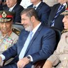 Egyptian President Mohamed Mursi (C) speaks with Field Marshal Hussein Tantawi (L) and Egyptian...