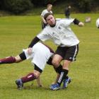 Dunedin Technical's Aaron Burgess takes a tumble as he challenges Roslyn-Wakari's Sean Brand...
