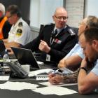 Emergency and social services staff respond to the information on damage from a major simulated...