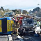 Emergency services at the scene of a crash involving two cars and bus in Caversham Valley Rd,...