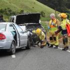 Emergency services clean up the scene of a serious accident on Highcliff Rd on Saturday after a...