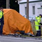 Emergency services personnel and police attend the scene of a fatal collision between a truck and...