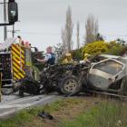 Emergency  services personnel at the scene of a crash on State Highway 1 near Maheno yesterday....