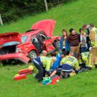 Emergency services staff attend to people involved in a two-car collision in Dunedin yesterday....