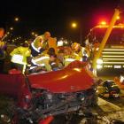Emergency services staff work to free a 14-year-old girl from a car following a high-speed crash...
