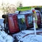 Emergency services work to secure an accident scene after a four-wheel-drive vehicle crashed on...