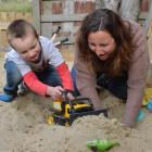 Emma Currie enjoys some time in the sandpit with son Eli (4).  Photo by Gerard O'Brien.