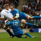 England's Geoff Parling (L) is tackled by Italy's Sergio Parisse (R) and Gonzalo Garcia during...