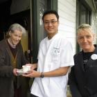 Enid Ford (left)  receives a meal from  Unichem Knox Pharmacy's dispensing manager Shin wei Chan ...