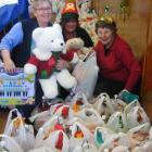 Enjoying preparing food parcels and gifts to distribute to  families in need are (from left)...