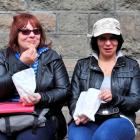 Enjoying some chips outside the Dunedin Law Courts yesterday are Pacific Pearl passengers Jackie...