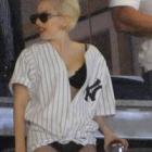 Entertainer Lady Gaga, right, watches the New York Yankees play the New York Mets in a baseball...
