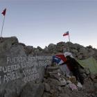 Ercilia Carrizo Munoz stands next to a Chilean flag as she waits for her son Esteban Rojas...