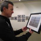 Eric Schusser, of Alexandra,  judges line-themed photographs in an exhibition and competition  at...