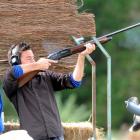 Eyes jammed firmly shut, Otago Daily Times reporter Chris Morris blasts a clay target with a...