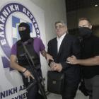 Far-right Golden Dawn party leader Nikos Mihaloliakos (centre) is escorted by anti-terrorism...