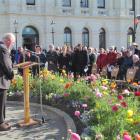 Father Wayne Healey leads in prayer about 400 people at a World War 1 centennial  commemoration...