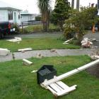 Fence palings and broken bricks landed on the front lawn of the Odell family's property in...