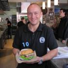 Fergburger general manager Barry Smith holds a specially adorned burger in a rare, less hectic...