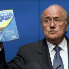 FIFA President Sepp Blatter holds the FIFA Code of Ethics while talking to the media during a...