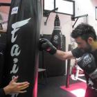 Fight Science Gym owner Braden Lee (left) holds a punch bag while head trainer Stewart Mitchell...