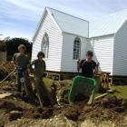 Finishing off excavations at Pukehiki Church on Otago Peninsula are (from left) 18-year-olds Fin...