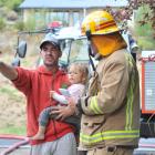 Frenchman Julien Arriaga and his daughter Lola Arriaga-Power (2) with St Kilda station officer Ed...